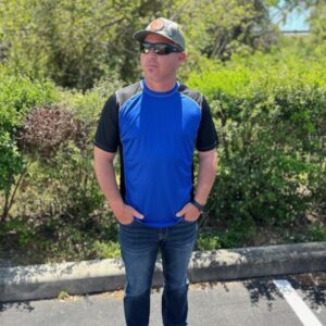 Blue activewear workout shirt with black sleeves.